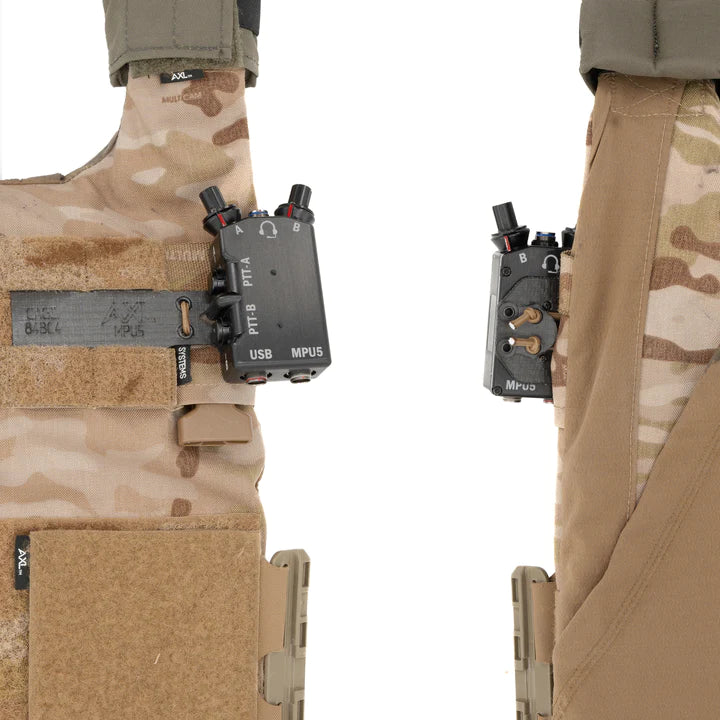 P/N: 14103-TBD: The CommSled mounts the PTT offset to the carrier and flexibly allows clearance of ATAK and similar systems, as well as lower profile mounting and improved access to PTT controls. Using shockcord, the CommSled pulls the PTT's outer edge into the plate carrier's intercostal space and keeps it spaced so that EUD devices can be used without interference by larger PTTs.